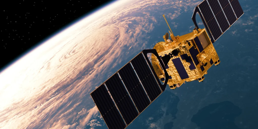 Satellite orbiting Earth with visible continents and atmosphere.